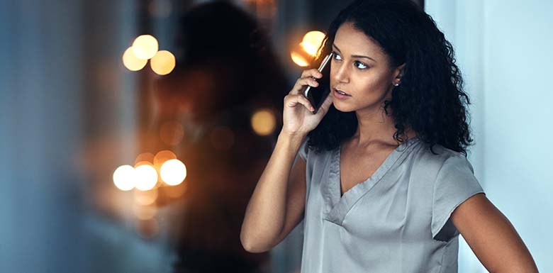 Woman talking on the phone looking suspicious