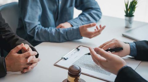 Two men talking to lawyer