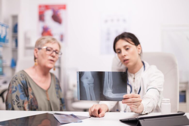 A doctor shows a slip-and-fall patient a copy of her x-ray, which can be used to prove liability in the patient's Detroit premises liability case.